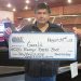 person holding large check