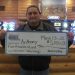 Person holding large check