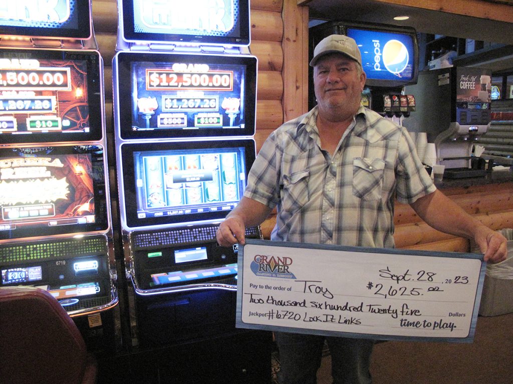 Person holding a large check
