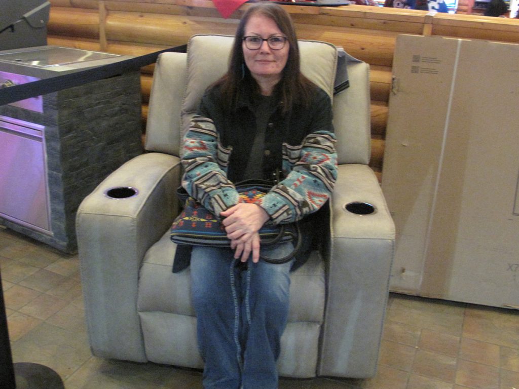 Lady sitting on prize of recliner