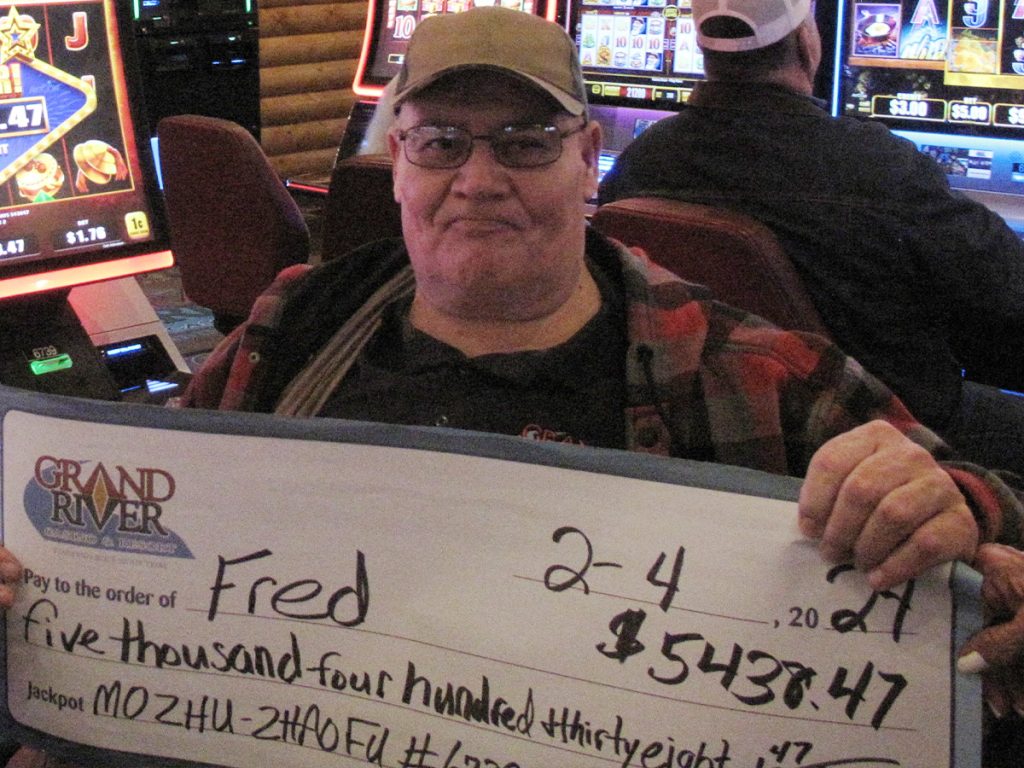 Person holding large check