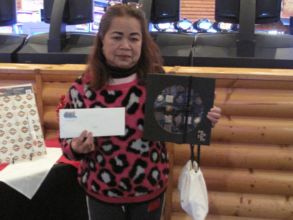 Woman holding envelope and prize
