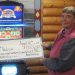 Person holding large winner check