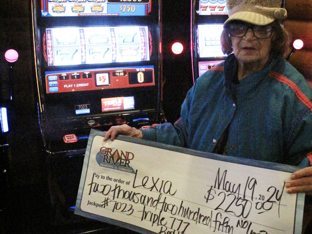 Person holding large winner check