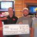 4 men holding large winner check