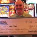 Person holding large winner check